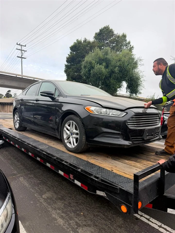 Ford Fusion secured on the transport trailer during delivery